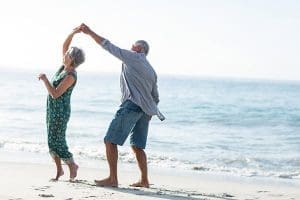 Elderly dancing in sand