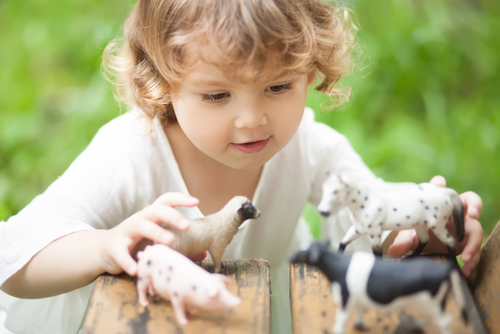 toddler playing with horses small2