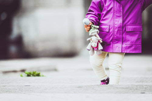 Toddler holding comforter